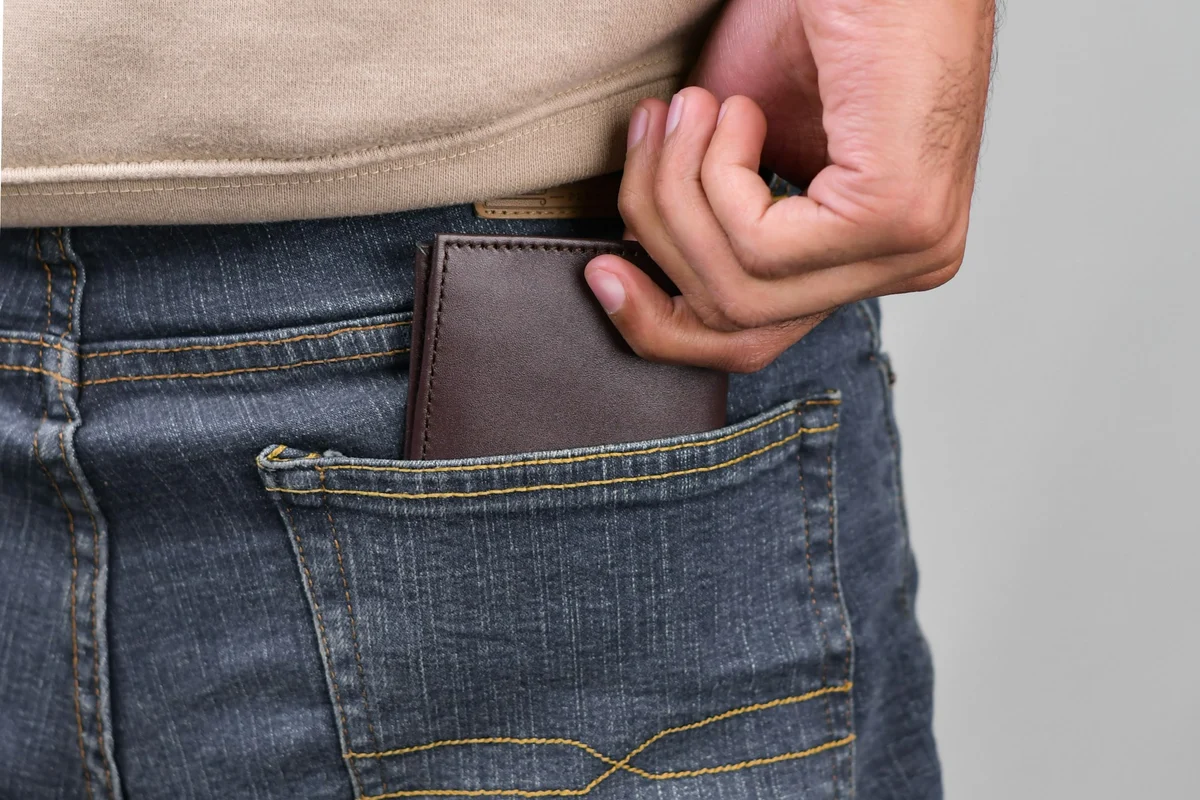 Slim leather bifold wallet showing its size and back-pocket fit