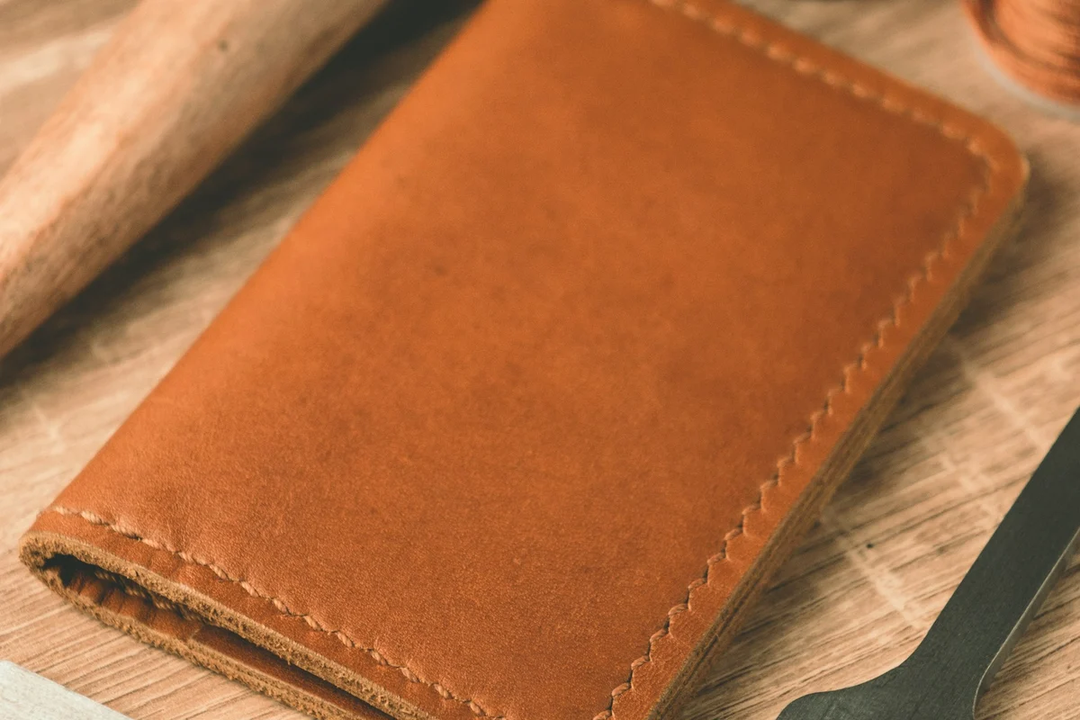 Close-up of a leather wallet's stitching and edge construction