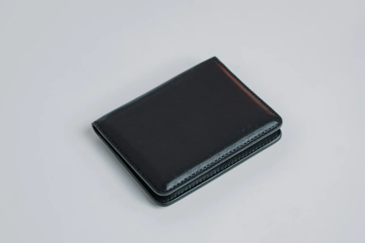 Brown men's leather bifold wallet on a light background