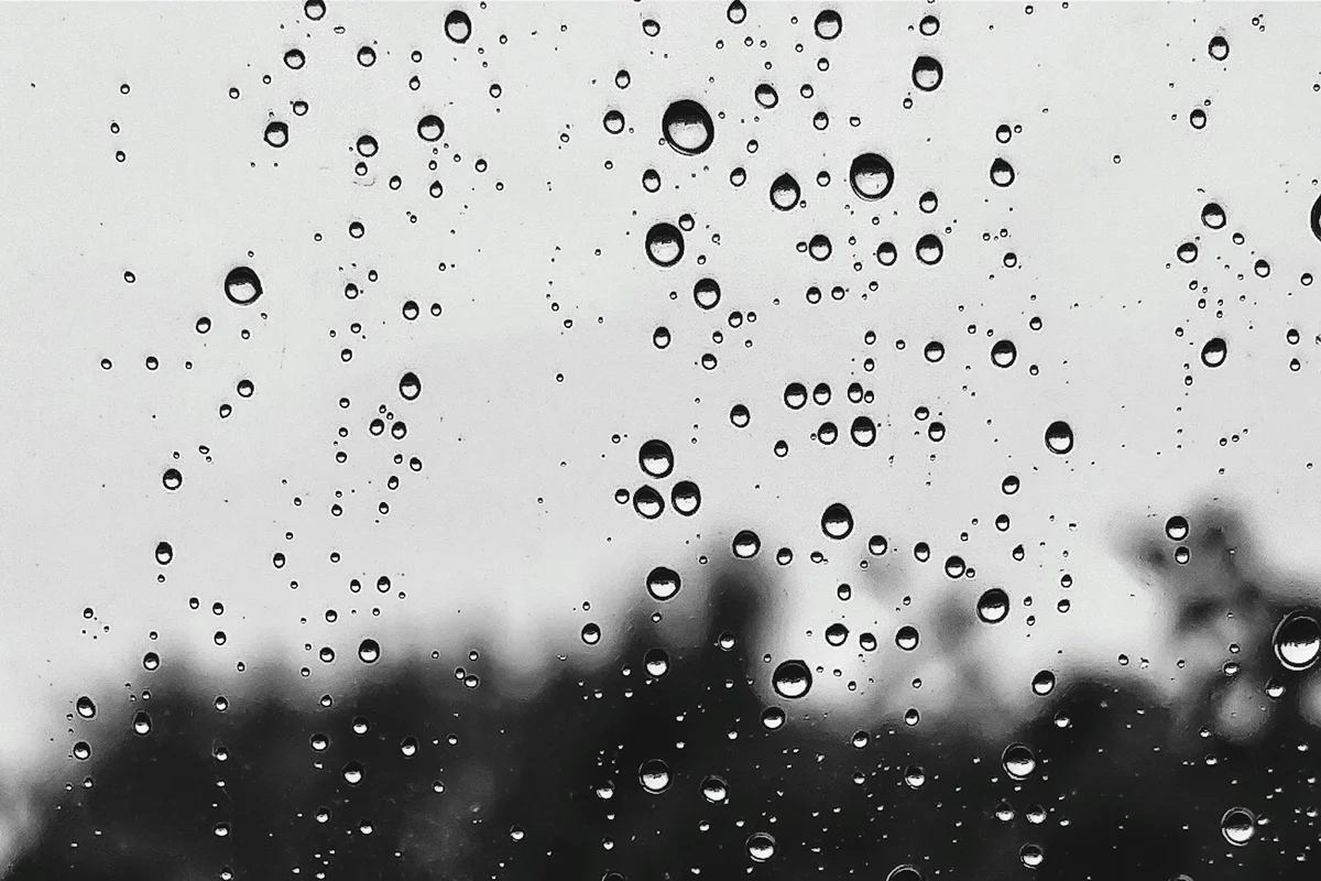 Monsoon rain running down a window, the humidity that damages leather in Bangladesh
